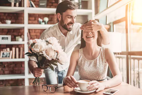 married man giving his wife flowers