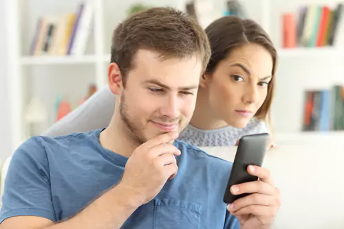 Is he cheating? Girlfriend looking over shoulder
